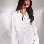 White pinstriped shirt dress styled as mini dress with pointed toe heels — Deme Studio | Endless UAE