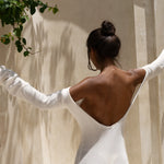 Strapless white tunic draped elegantly on model in sunlit architectural setting — Nuverance | Endless UAE