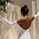 Strapless white tunic draped elegantly on model in sunlit architectural setting — Nuverance | Endless UAE