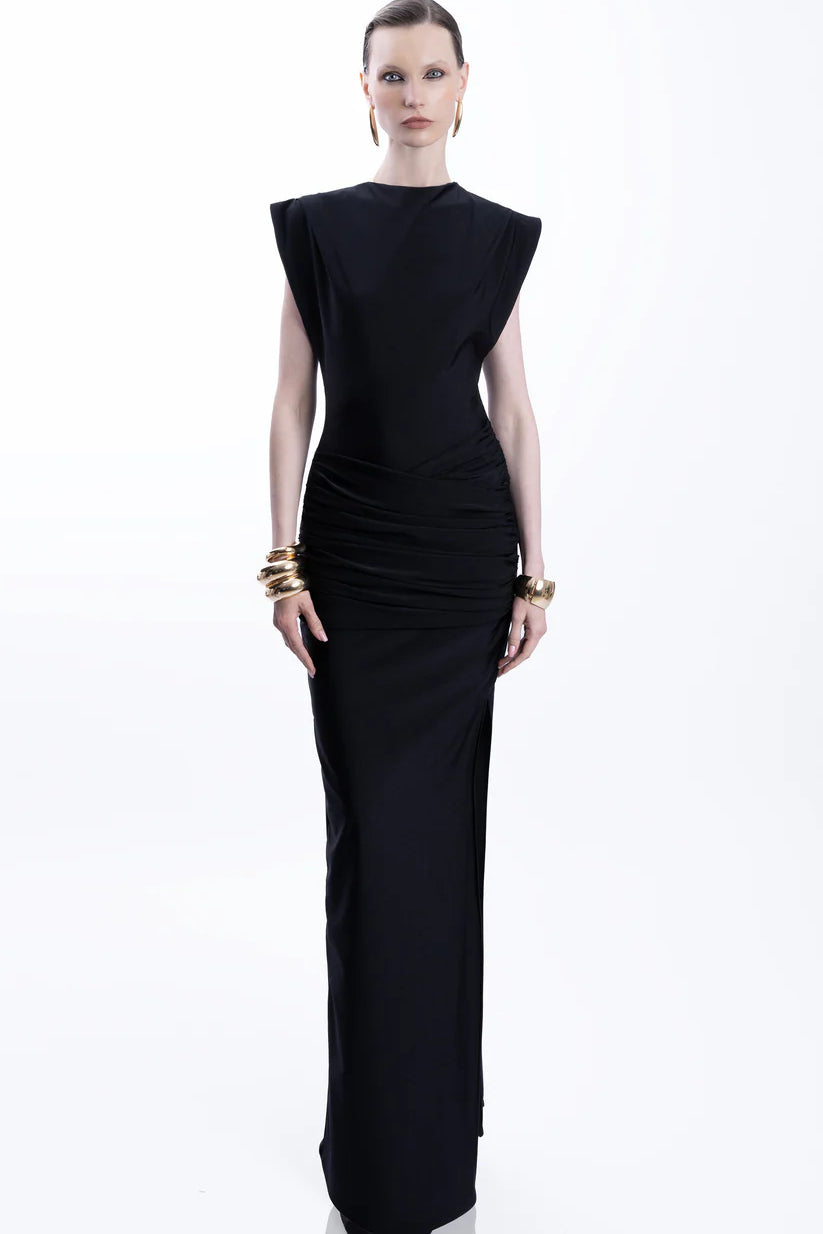 Woman wearing black sleeveless maxi dress with ruched side detail and gold bangles — Lediel | Endless UAE