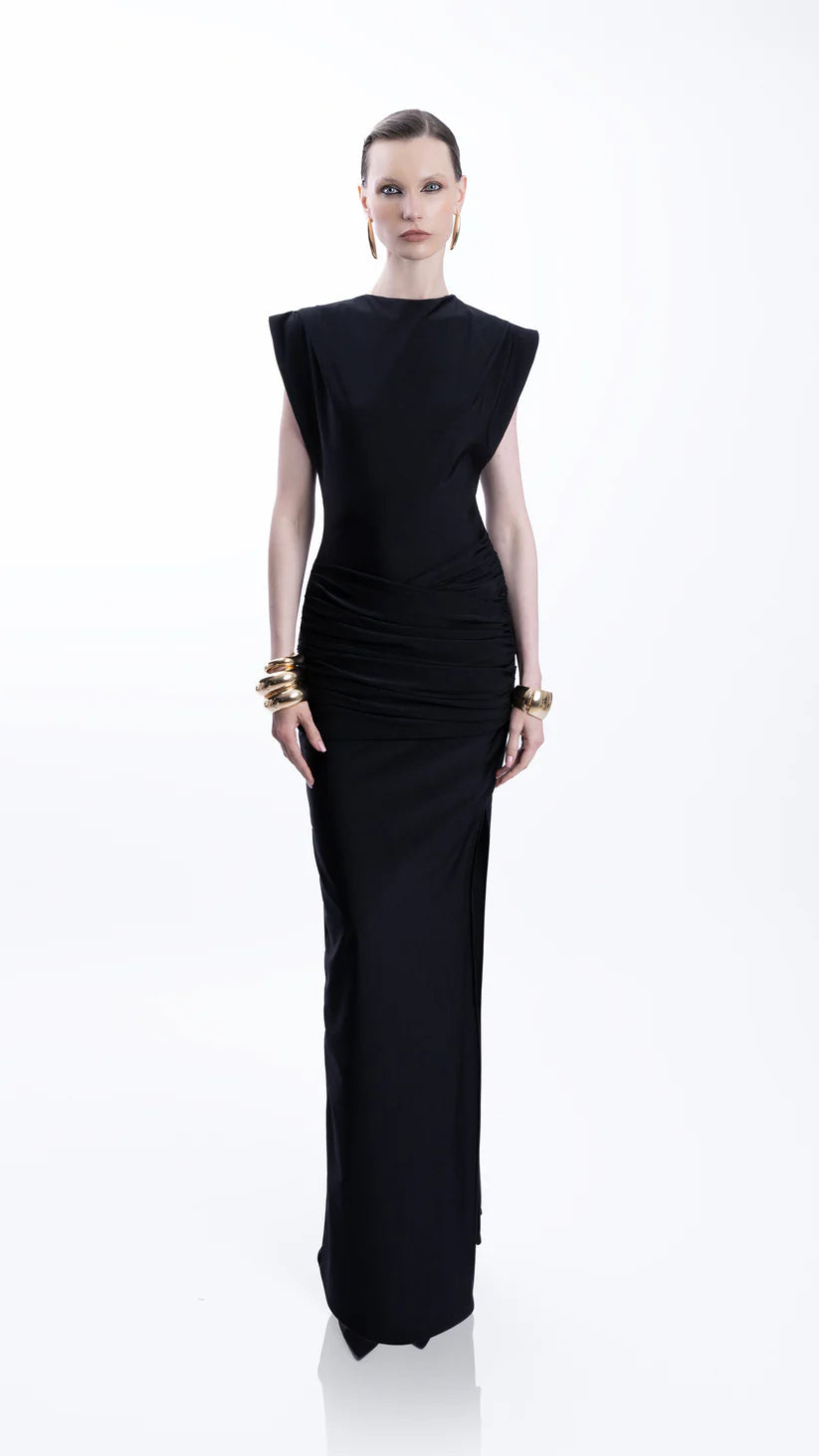Woman wearing black sleeveless maxi dress with ruched side detail and gold bangles — Lediel | Endless UAE