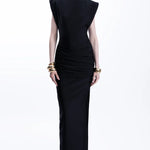 Woman wearing black sleeveless maxi dress with ruched side detail and gold bangles — Lediel | Endless UAE