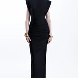 Woman wearing black sleeveless maxi dress with ruched side detail and gold bangles — Lediel | Endless UAE