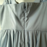 Woman wearing light blue sleeveless midi dress with corset top and full skirt — Endless | Endless UAE