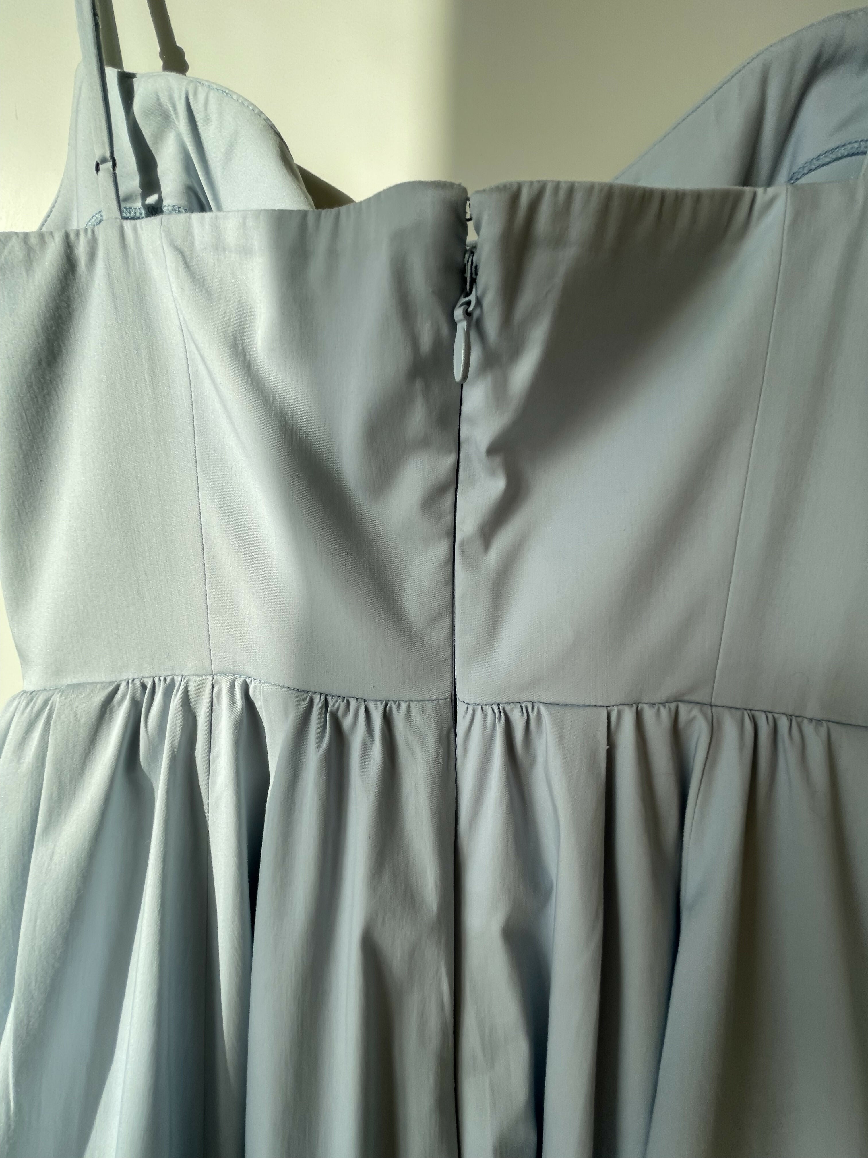 Woman wearing light blue sleeveless midi dress with corset top and full skirt — Endless | Endless UAE