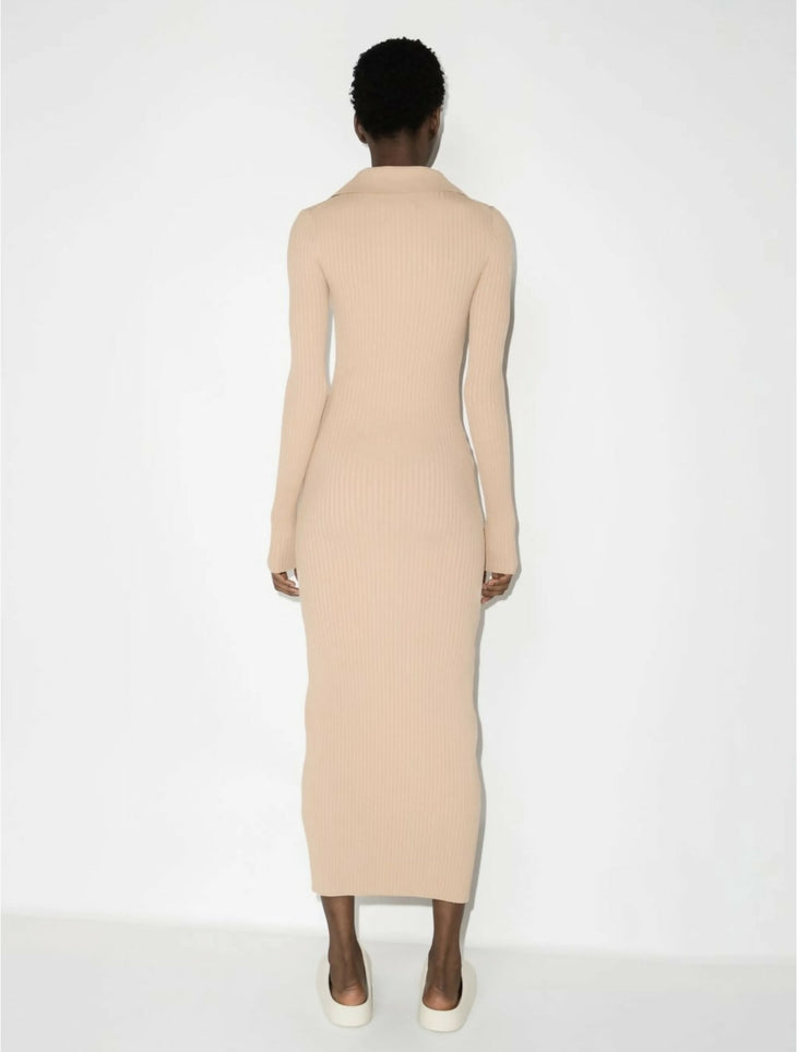 Rear view of beige ribbed knit midi dress with long sleeves and collar, worn with white sneakers — Nanushka | Endless UAE