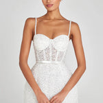 Elegant white mini dress with pearl embellishments, corset bodice, and sheer lace panel detail — Nadine Merabi | Endless UAE