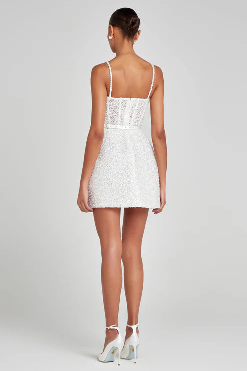 Short white sequin mini dress with thin straps worn from back view — Nadine Merabi | Endless UAE