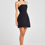 Woman wearing black sleeveless dress with white pearl neckline and straps — Nadine Merabi | Endless UAE