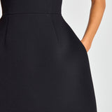 Woman wearing black sleeveless dress with white pearl neckline and straps — Nadine Merabi | Endless UAE