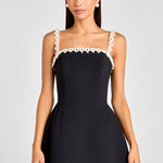 Woman wearing black sleeveless dress with white pearl neckline and straps — Nadine Merabi | Endless UAE
