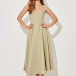 Woman wearing sage green square neck midi dress with pleated skirt and white slide sandals — Odd Muse | Endless UAE