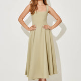 Woman wearing sage green square neck midi dress with pleated skirt and white slide sandals — Odd Muse | Endless UAE