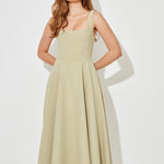 Woman wearing sage green square neck midi dress with pleated skirt and white slide sandals — Odd Muse | Endless UAE