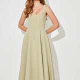 Woman wearing sage green square neck midi dress with pleated skirt and white slide sandals — Odd Muse | Endless UAE