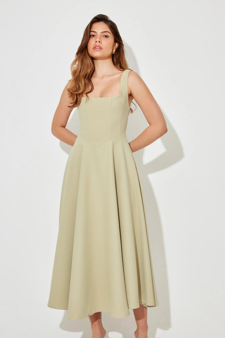 Woman wearing sage green square neck midi dress with pleated skirt and white slide sandals — Odd Muse | Endless UAE