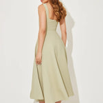 Woman wearing sage green square neck midi dress with pleated skirt and white slide sandals — Odd Muse | Endless UAE