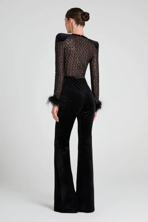 Black velvet flared jumpsuit with sheer lace back and feather cuff details — Nadine Merabi | Endless UAE