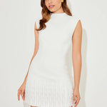 Woman wearing white sleeveless dress with fringe hem and white heels — Odd Muse | Endless UAE