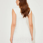 Woman wearing white sleeveless dress with fringe hem and white heels — Odd Muse | Endless UAE