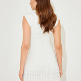 Woman wearing white sleeveless dress with fringe hem and white heels — Odd Muse | Endless UAE