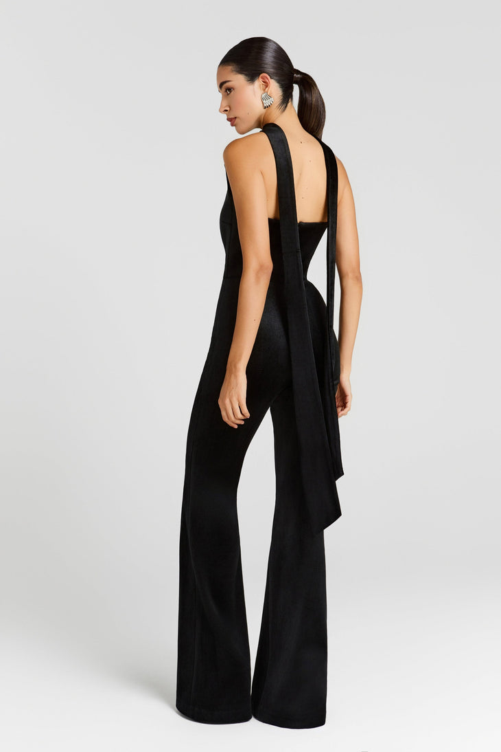 Black velvet jumpsuit with dramatic open back and flowing cape detail, wide-leg silhouette — Nadine Merabi | Endless UAE