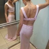 Elegant pink high-waisted maxi skirt with matching crop top set, featuring floor-length silhouette and backless design — By Keara | Endless UAE