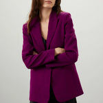 Woman wearing a vibrant purple single breasted blazer with black outfit against neutral background — Endless Rose | Endless UAE