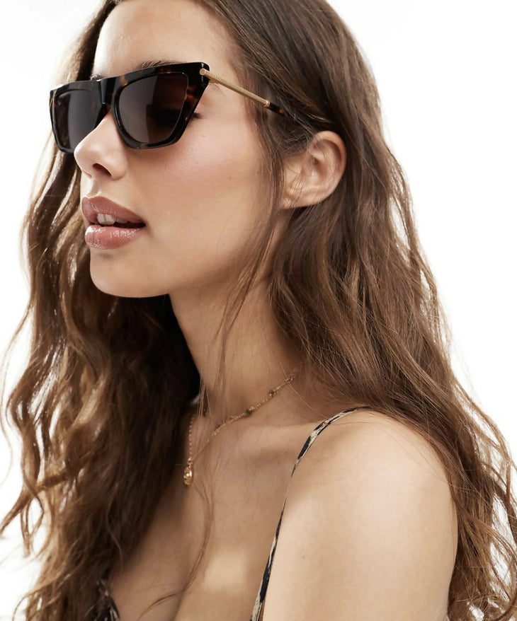 Minka Sunglasses in tortoiseshell with gold metal arms, worn by model in profile view — All Saints | Endless UAE