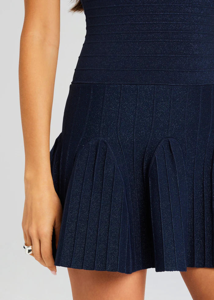 Navy blue knit dress with pleated skirt detail, close-up of fitted waist and pleats — Retrofete | Endless UAE