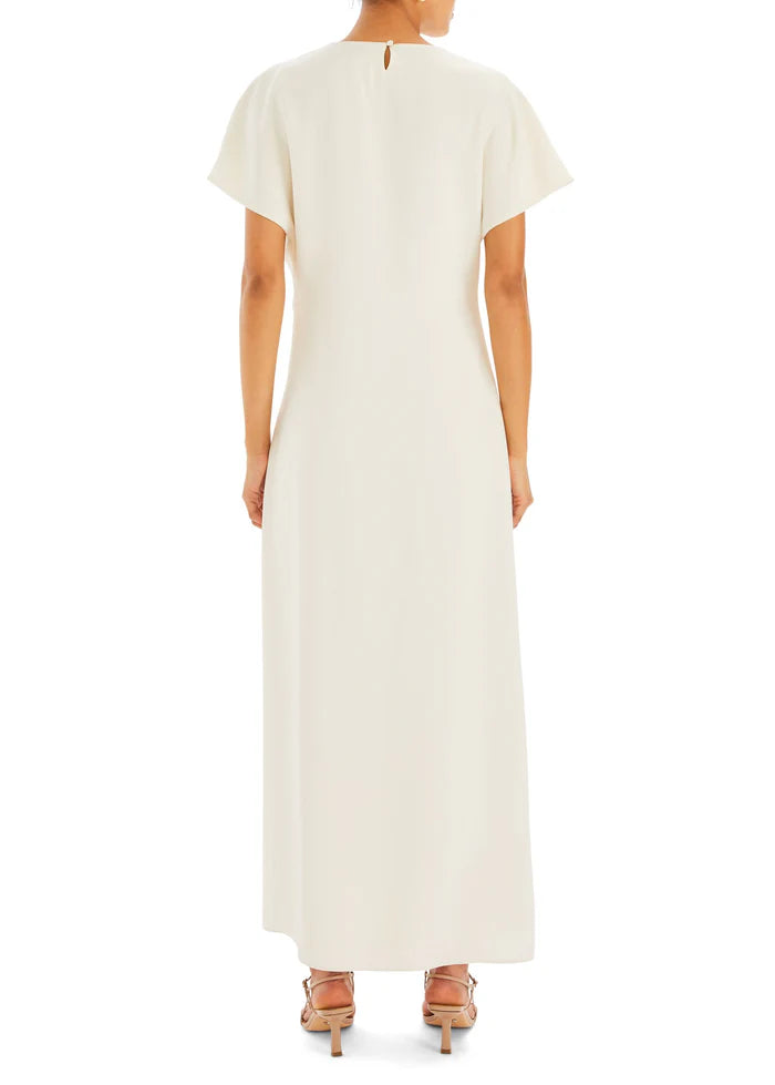 Woman wearing cream Tropez Maxi Dress with side slit, straw bag and strappy heels — SER.O.YA | Endless UAE