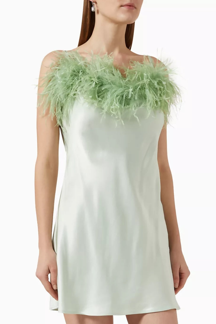 Boheme Ecovero mini slip dress with green feather trim, styled with silver bag and strappy heels — Sleeper | Endless UAE