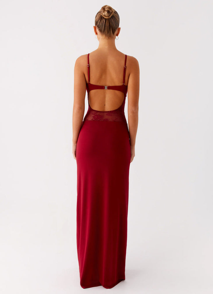 Rear view of woman wearing burgundy red maxi dress with open back cutout and lace detail — Peppermayo | Endless UAE
