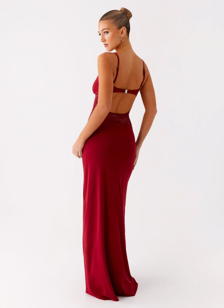 Woman wearing burgundy backless maxi dress with thin straps and cut-out detail — Peppermayo | Endless UAE