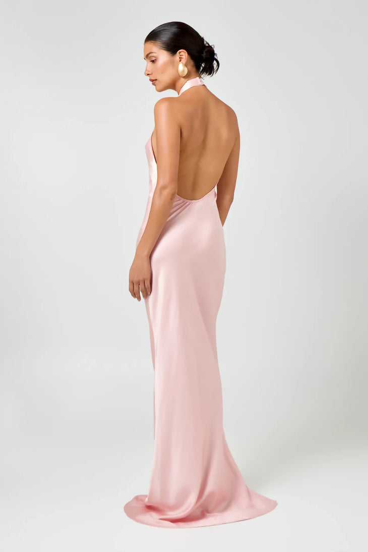 Elegant pink satin halter neck maxi dress with open back, floor-length silhouette, worn by model in studio — Hyphen | Endless UAE