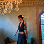 Elegant black halter top and navy skirt set worn by model in luxurious room with chandelier — With Jean | Endless UAE