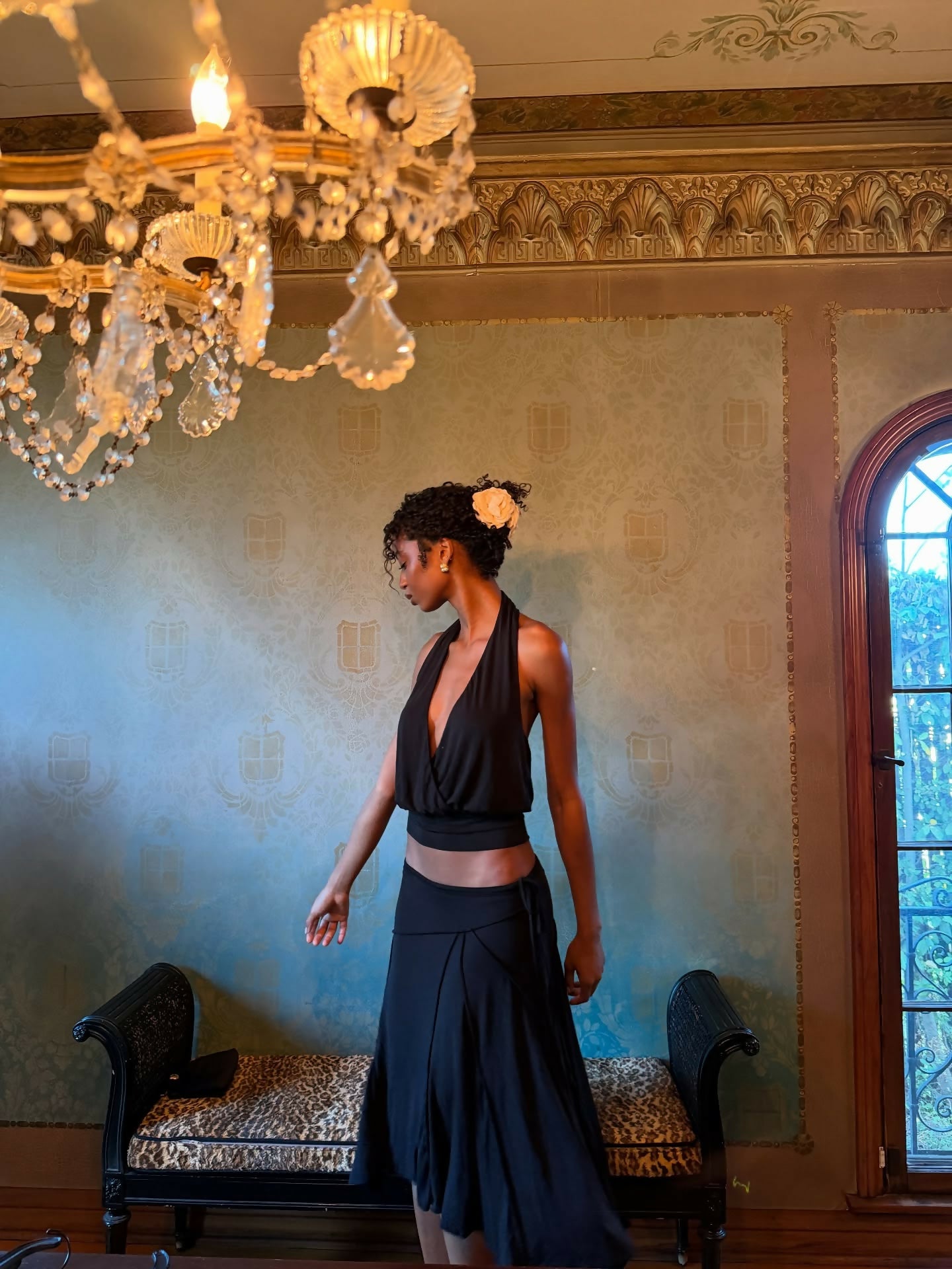Elegant black halter top and navy skirt set worn by model in luxurious room with chandelier — With Jean | Endless UAE