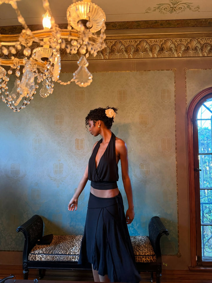 Elegant black halter top and navy skirt set worn by model in luxurious room with chandelier — With Jean | Endless UAE