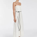 Woman wearing strapless cream marle midi dress with black tie belt and black sandals on white background — Dissh | Endless UAE