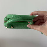 Green crocodile-embossed mini tote bag with gold hardware held by hand — By Far | Endless UAE