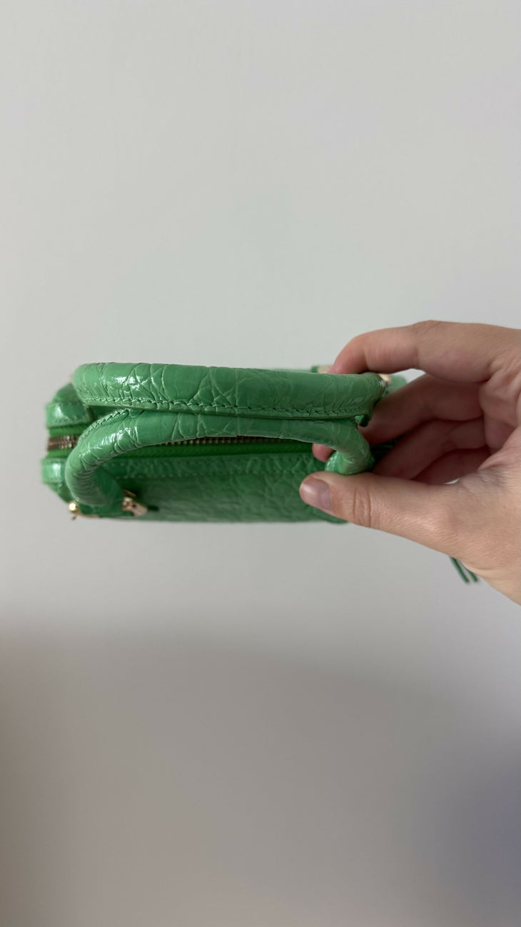 Green crocodile-embossed mini tote bag with gold hardware held by hand — By Far | Endless UAE