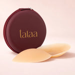 Beige silicone nipple covers displayed in front of burgundy zippered round case with gold Talaa logo — Talaa | Endless UAE