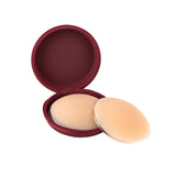 Beige silicone nipple covers with burgundy round storage case on white background — Talaa | Endless UAE