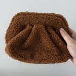 Gea Clutch in caramel brown textured fabric held in hand — TheMoire | Endless UAE
