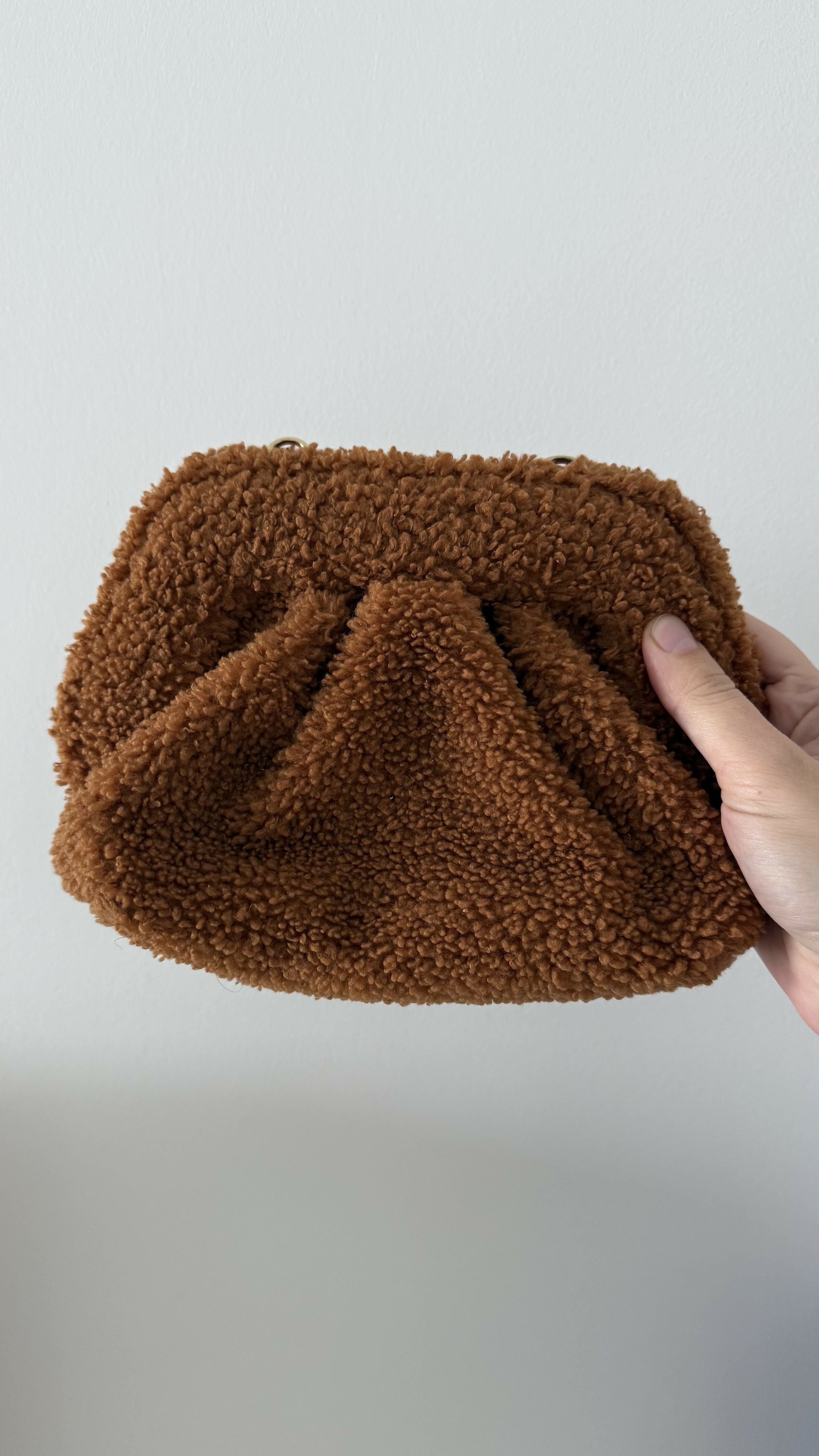 Gea Clutch in caramel brown textured fabric held in hand — TheMoire | Endless UAE