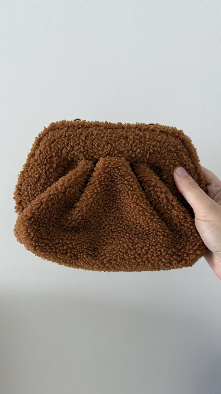 Gea Clutch in caramel brown textured fabric held in hand — TheMoire | Endless UAE
