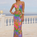 Colorful floral halter maxi dress with vibrant pink, purple, and green print — Runaway The Label | Endless UAE