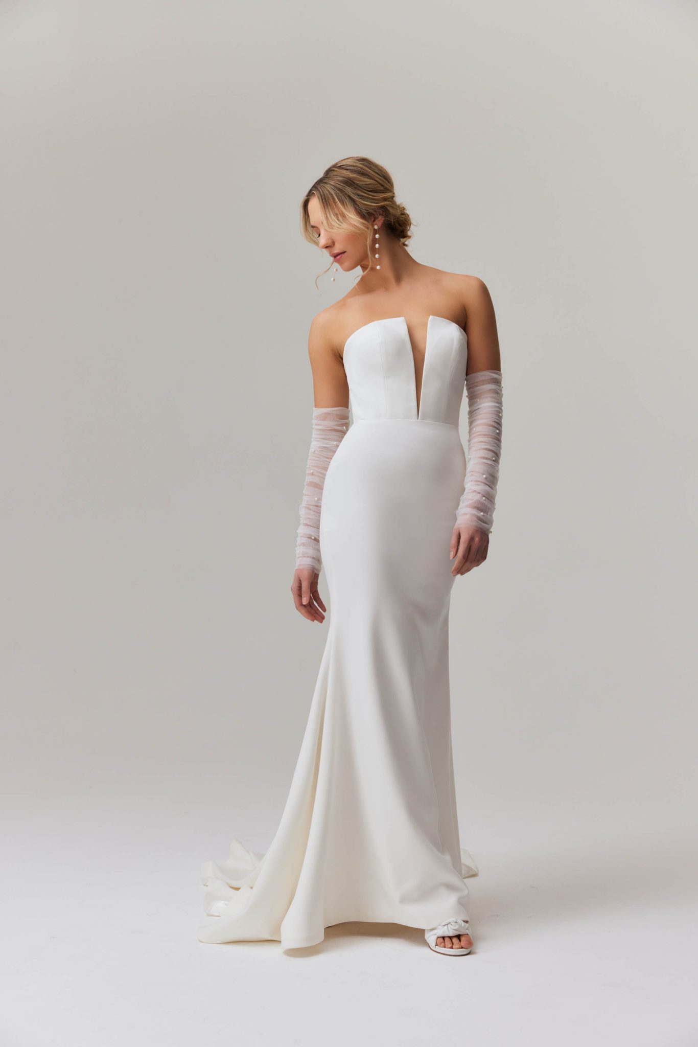 Elegant strapless mermaid wedding dress with plunging neckline and sheer tulle sleeves — You&I Bridal | Endless UAE