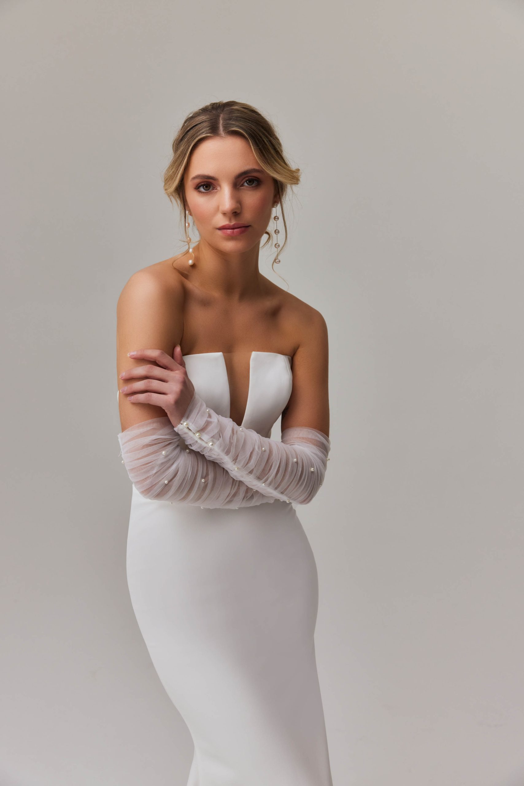 Elegant strapless mermaid wedding dress with plunging neckline and sheer tulle sleeves — You&I Bridal | Endless UAE