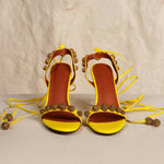 Bright yellow strappy heeled sandals with bronze embellished details and ankle tie closures — Subashini Heels | Endless UAE
